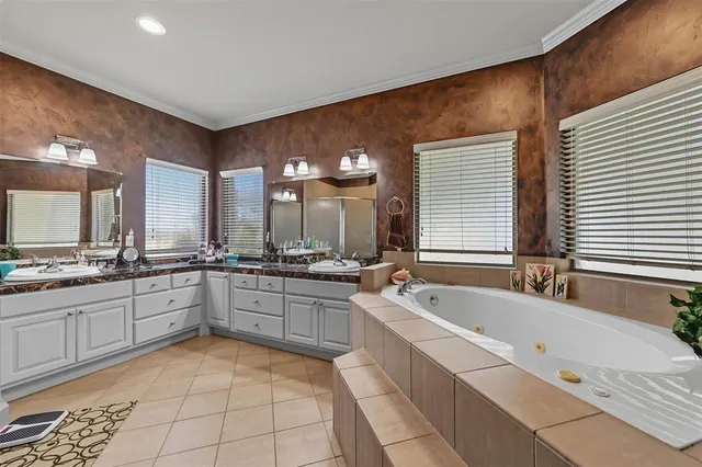 a large bathroom with a large tub and sink