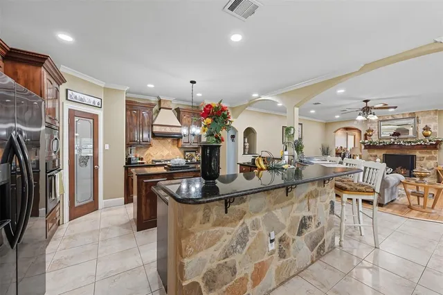 a kitchen with stainless steel appliances granite countertop a refrigerator and a sink