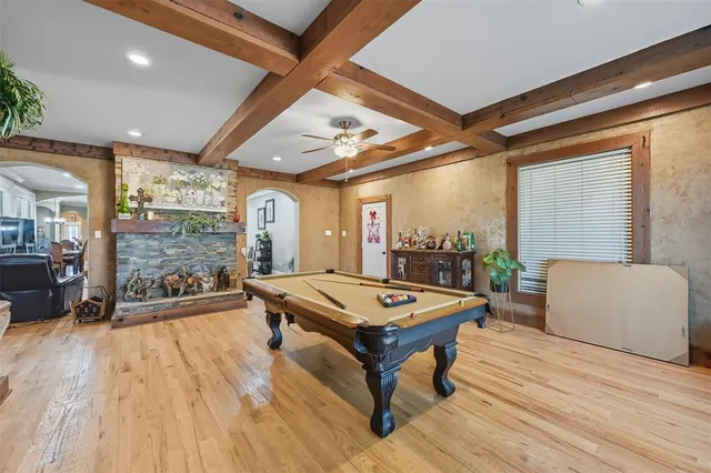 a living room with patio furniture and a wooden floor