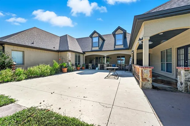 a view of a building with a garden and pathway