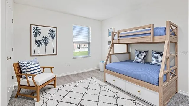 a bedroom with a bunk bed and a chair