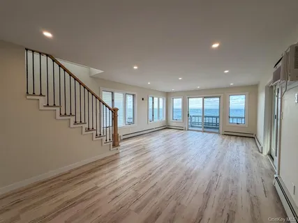 a view of an entryway with wooden floor
