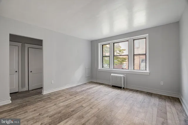 a view of an empty room and wooden floor