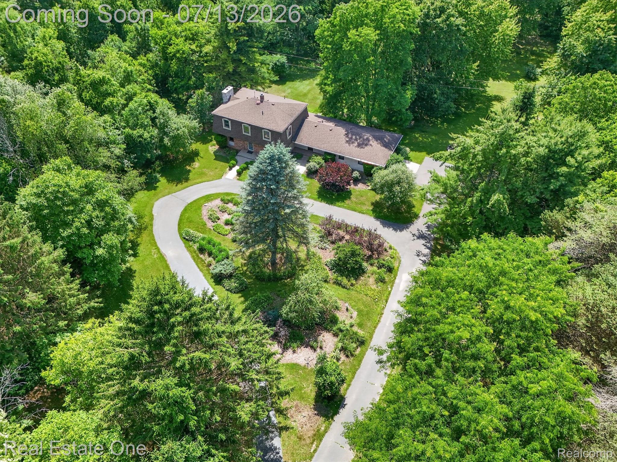 6039 Fish Lake Road Holly, MI 48442 - Photo 54 of 70 Expansive property with a brown-clad residence, surrounded by mature trees and lush greenery