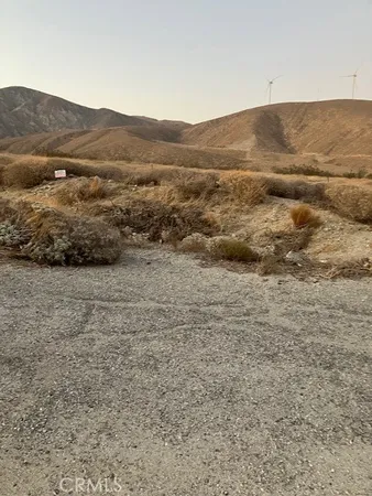 a view of a large mountain with mountains in the background