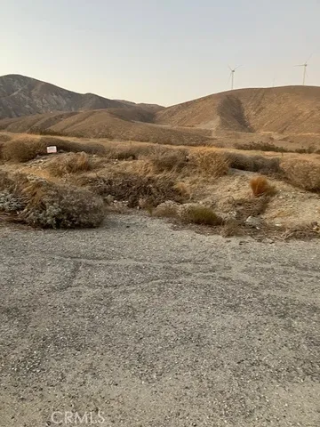 a view of a large mountain with mountains in the background