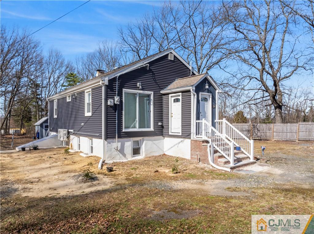 a view of a house with a yard covered in snow