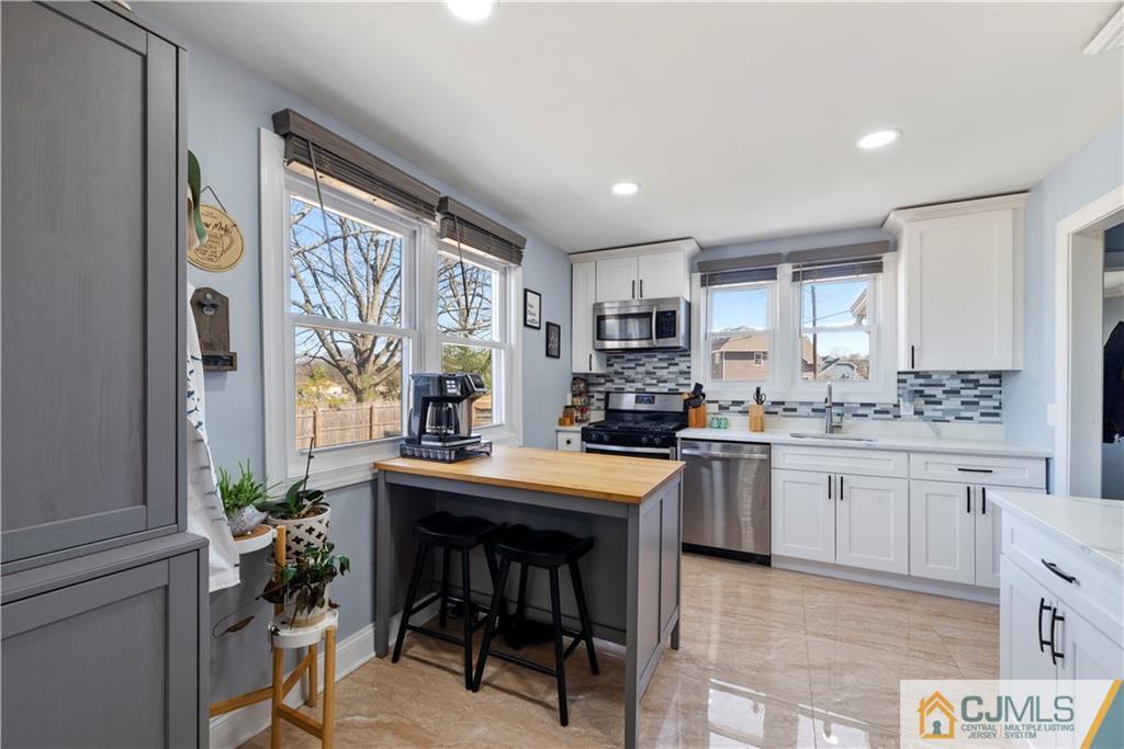 57 Dunhams Corner Road East Brunswick, NJ 08816 - Photo 11 of 31 a kitchen with sink cabinets and dining table chair