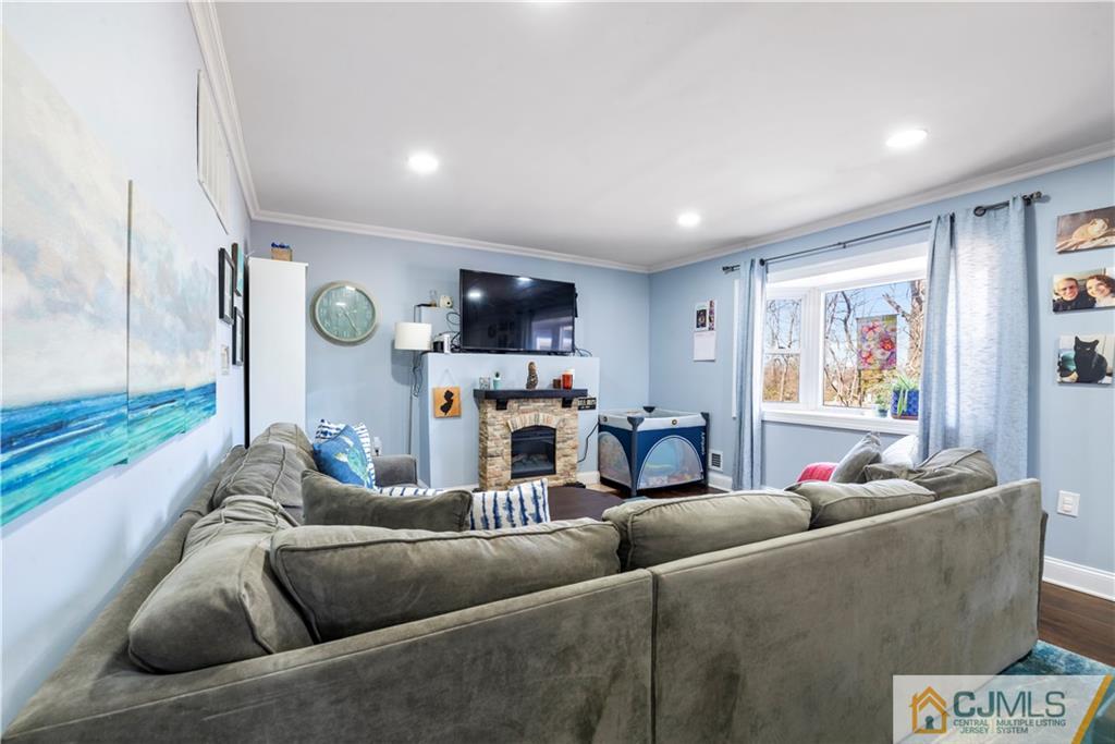 57 Dunhams Corner Road East Brunswick, NJ 08816 - Photo 13 of 31 a living room with furniture and a flat screen tv