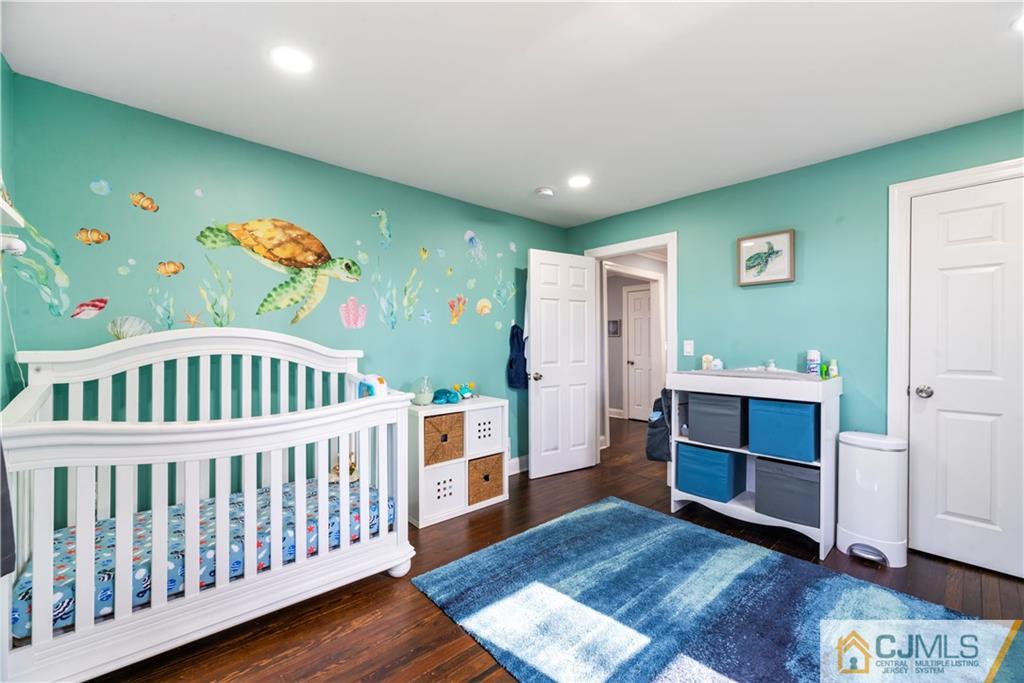 57 Dunhams Corner Road East Brunswick, NJ 08816 - Photo 16 of 31 a bedroom with furniture and a baby crib