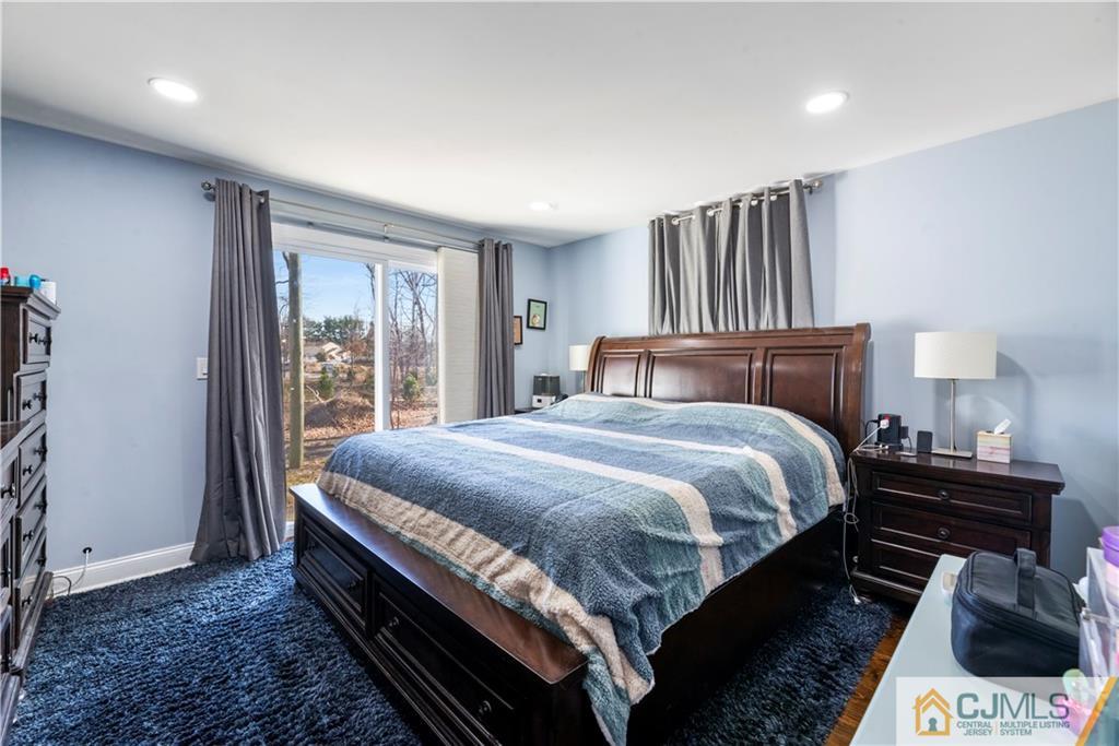 57 Dunhams Corner Road East Brunswick, NJ 08816 - Photo 17 of 31 a bedroom with a bed and wooden floor