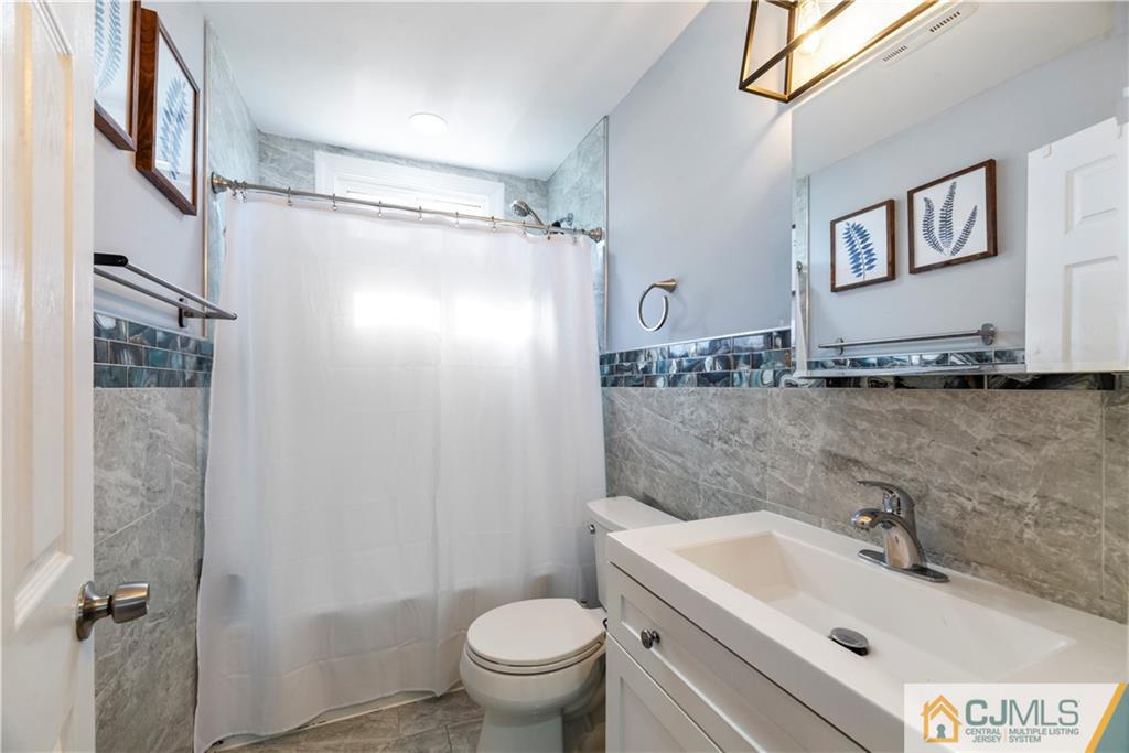 57 Dunhams Corner Road East Brunswick, NJ 08816 - Photo 19 of 31 a bathroom with a sink toilet and shower