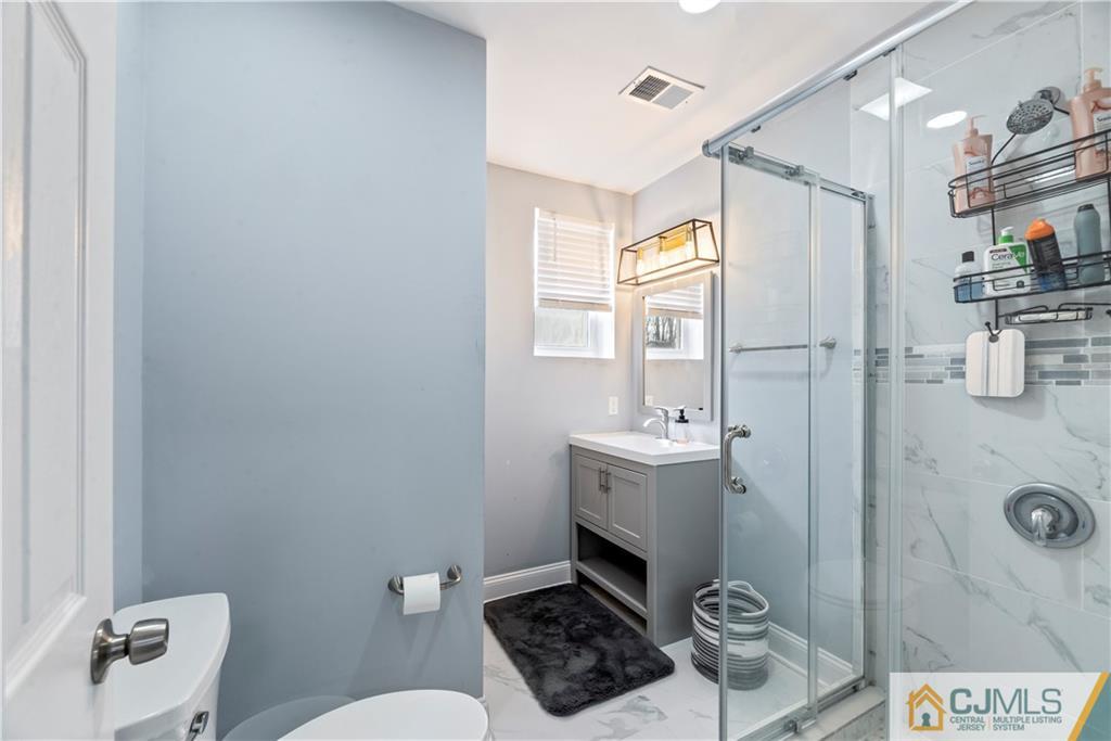 57 Dunhams Corner Road East Brunswick, NJ 08816 - Photo 27 of 31 a bathroom with a sink a toilet and shower