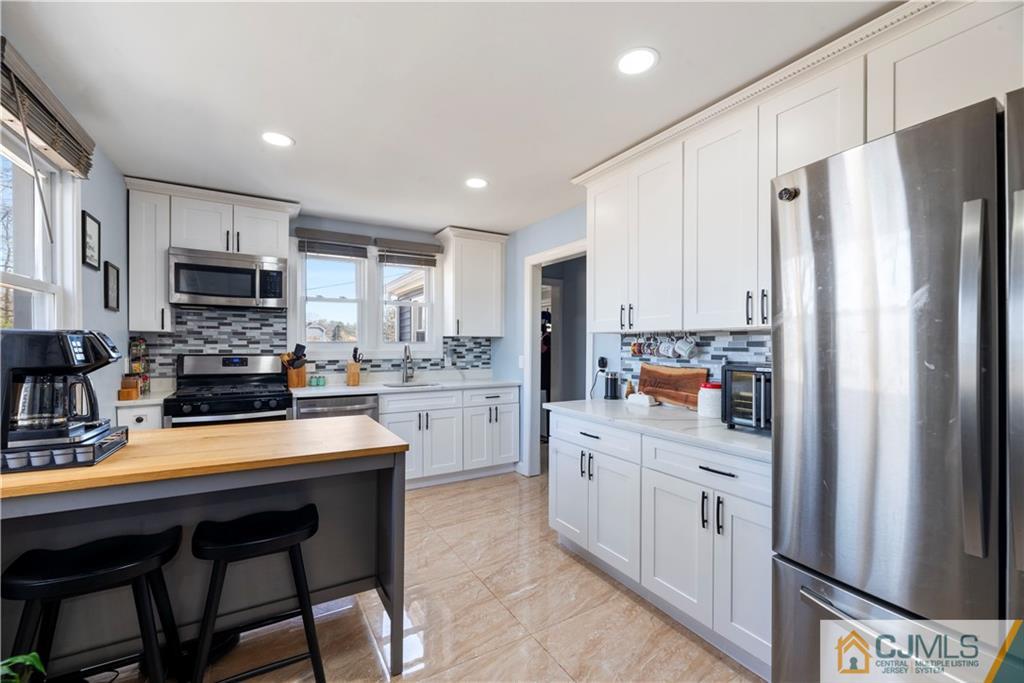 57 Dunhams Corner Road East Brunswick, NJ 08816 - Photo 10 of 31 a kitchen with stainless steel appliances a refrigerator sink and microwave