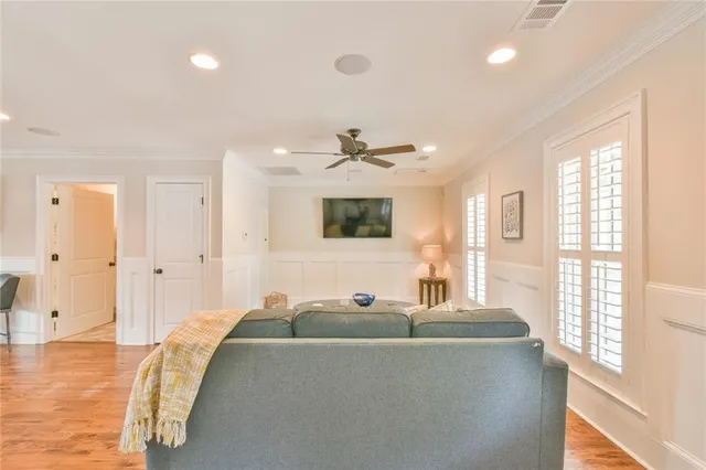 a view of a a dining room with furniture window and wooden floor