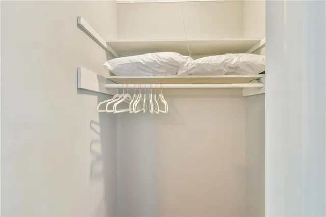 a bedroom with a bed and a ceiling fan