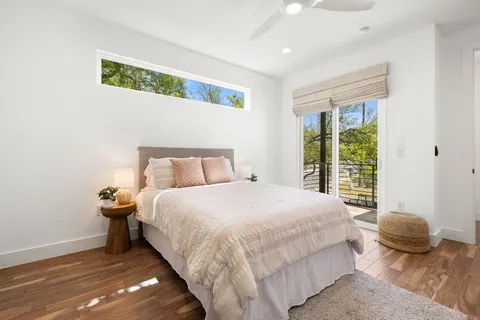 a bedroom with a bed and a potted plant