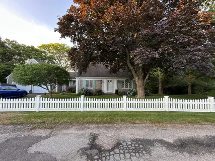 a flower garden is sitting in front of a house