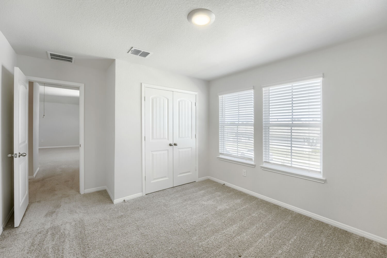 13507 Howser Trace Manor, TX 78653 - Photo 16 of 28 A well-lit room showcases ample space and natural light, ready for personalization.
