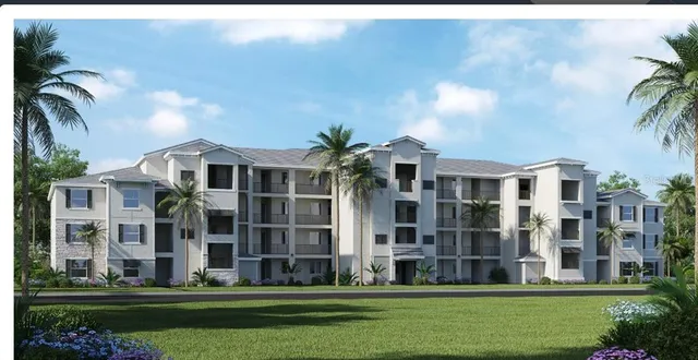 a front view of building with yard and trees