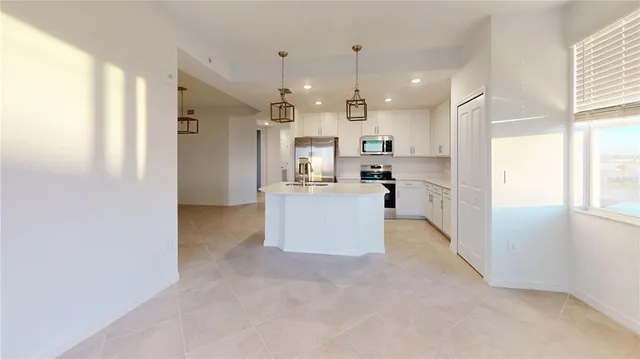 a kitchen with a refrigerator and a sink