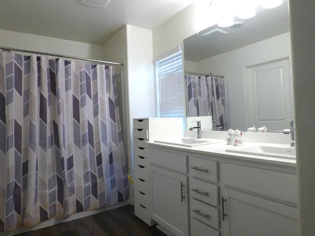 a bathroom with a double vanity sink and mirror
