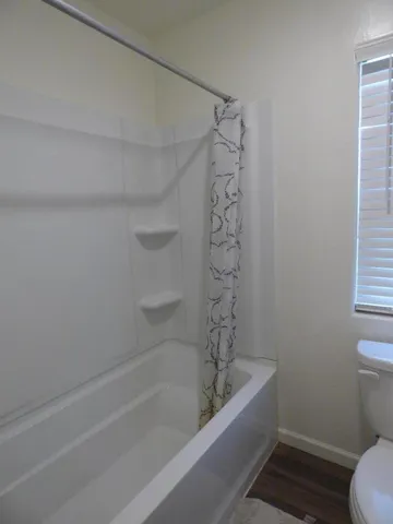 a bathroom with a bathtub and toilet