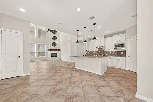 a kitchen with stainless steel appliances granite countertop a sink and cabinets