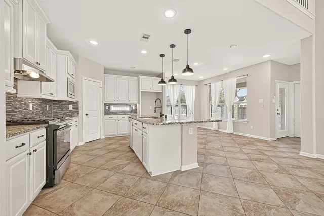 a bathroom with a sink and mirror with window