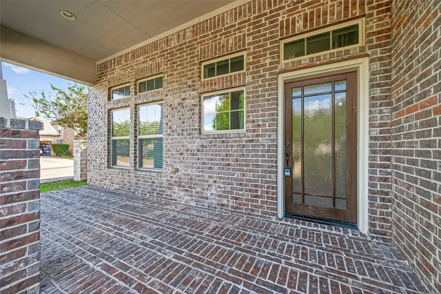 a view of a brick house with a large window
