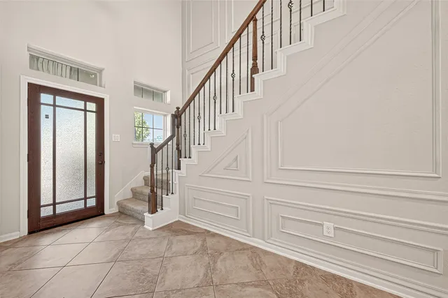 a view of an empty room with a fireplace and a window