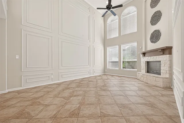 a view of an empty room with a fireplace and a window