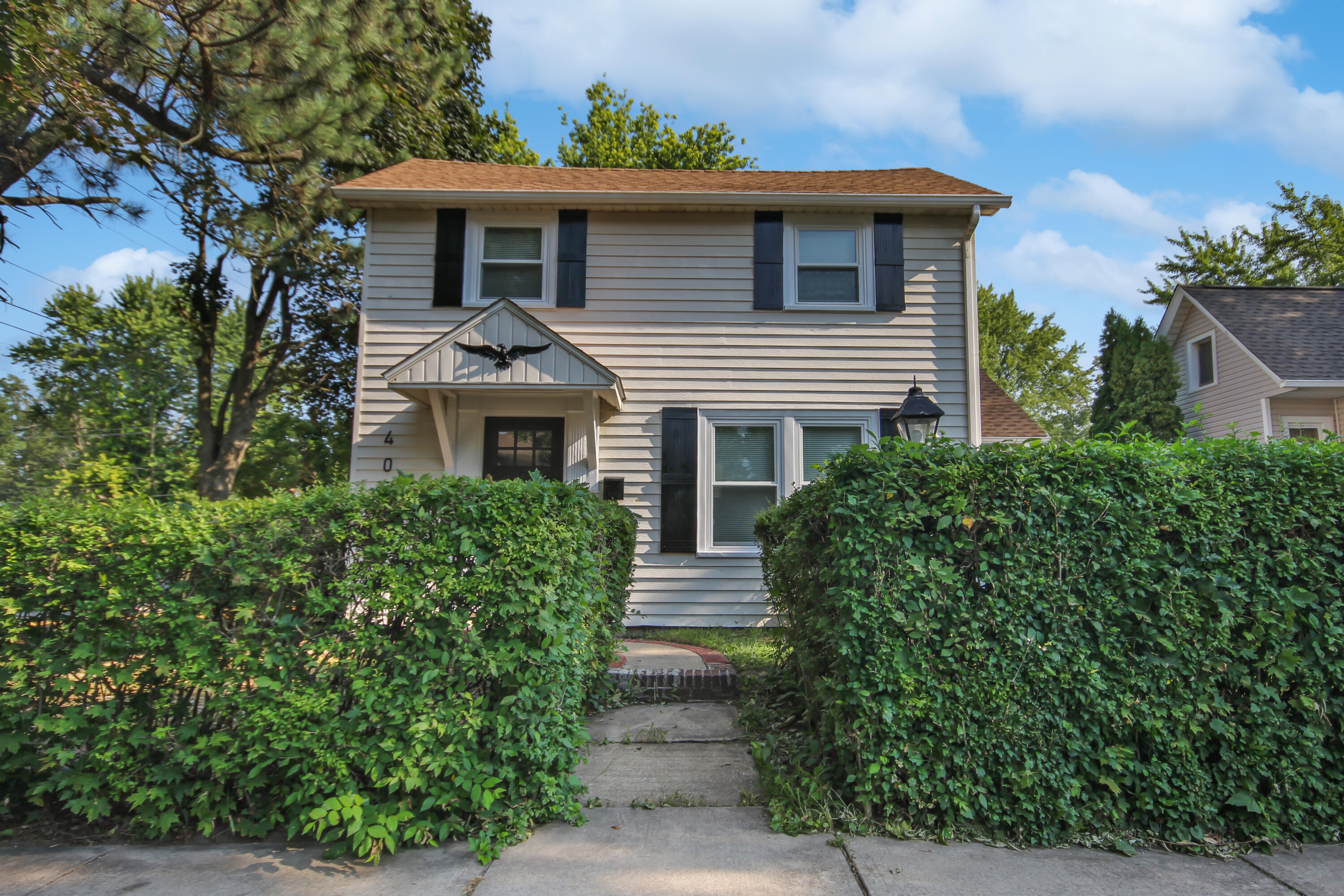 a front view of a house with garden