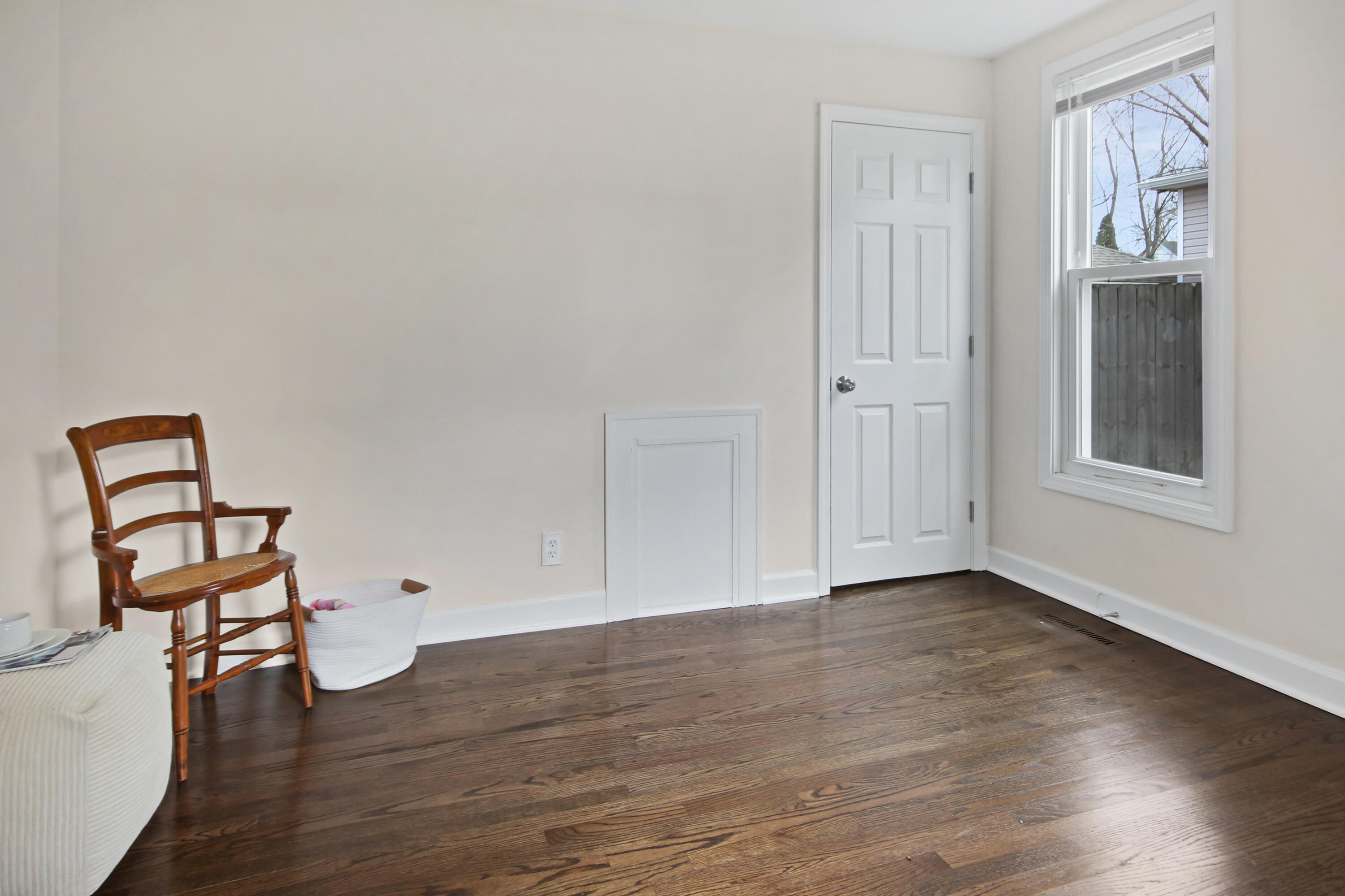 405 Institute Street Valparaiso, IN 46383 - Photo 13 of 17 an empty room with wooden floor cabinet and windows