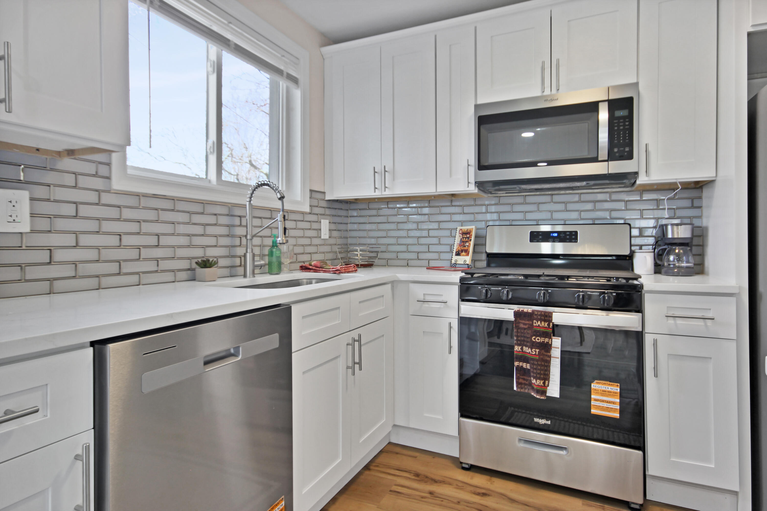 405 Institute Street Valparaiso, IN 46383 - Photo 5 of 17 a kitchen with stainless steel appliances granite countertop white cabinets a stove top oven a sink and dishwasher