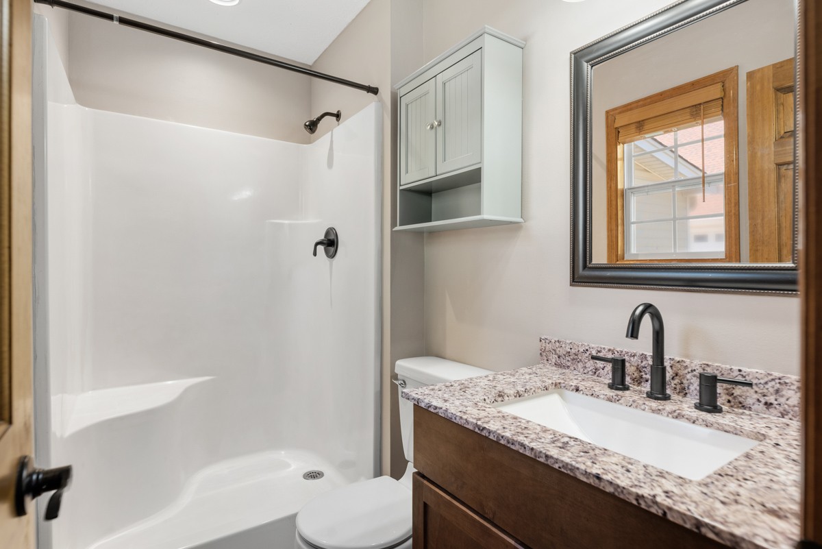 526 Calista Road White House, TN 37188 - Photo 15 of 29 a bathroom with a granite countertop sink a mirror and a bathtub