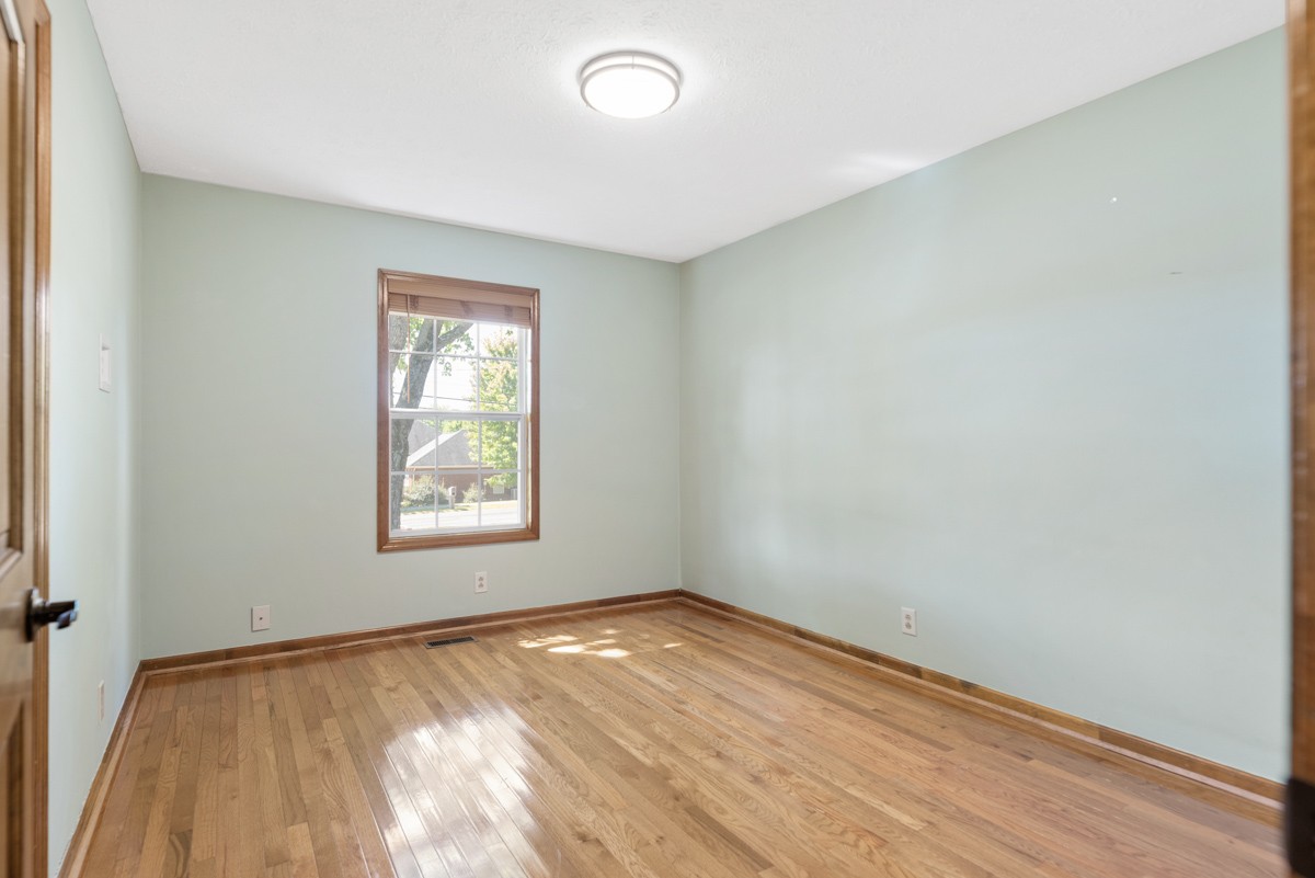 526 Calista Road White House, TN 37188 - Photo 17 of 29 an empty room with wooden floor and windows