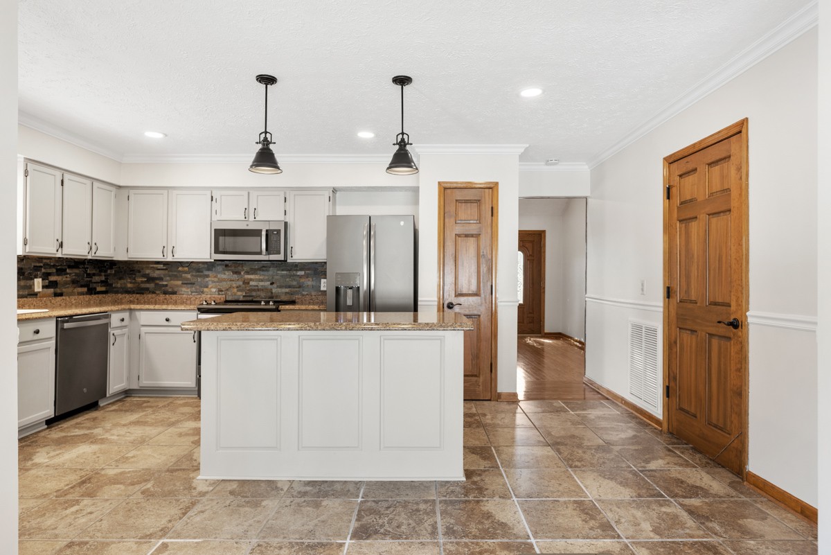 526 Calista Road White House, TN 37188 - Photo 6 of 29 a large kitchen with cabinets and stainless steel appliances