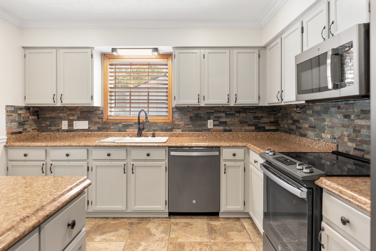 526 Calista Road White House, TN 37188 - Photo 8 of 29 a kitchen with stainless steel appliances granite countertop a stove sink and cabinets