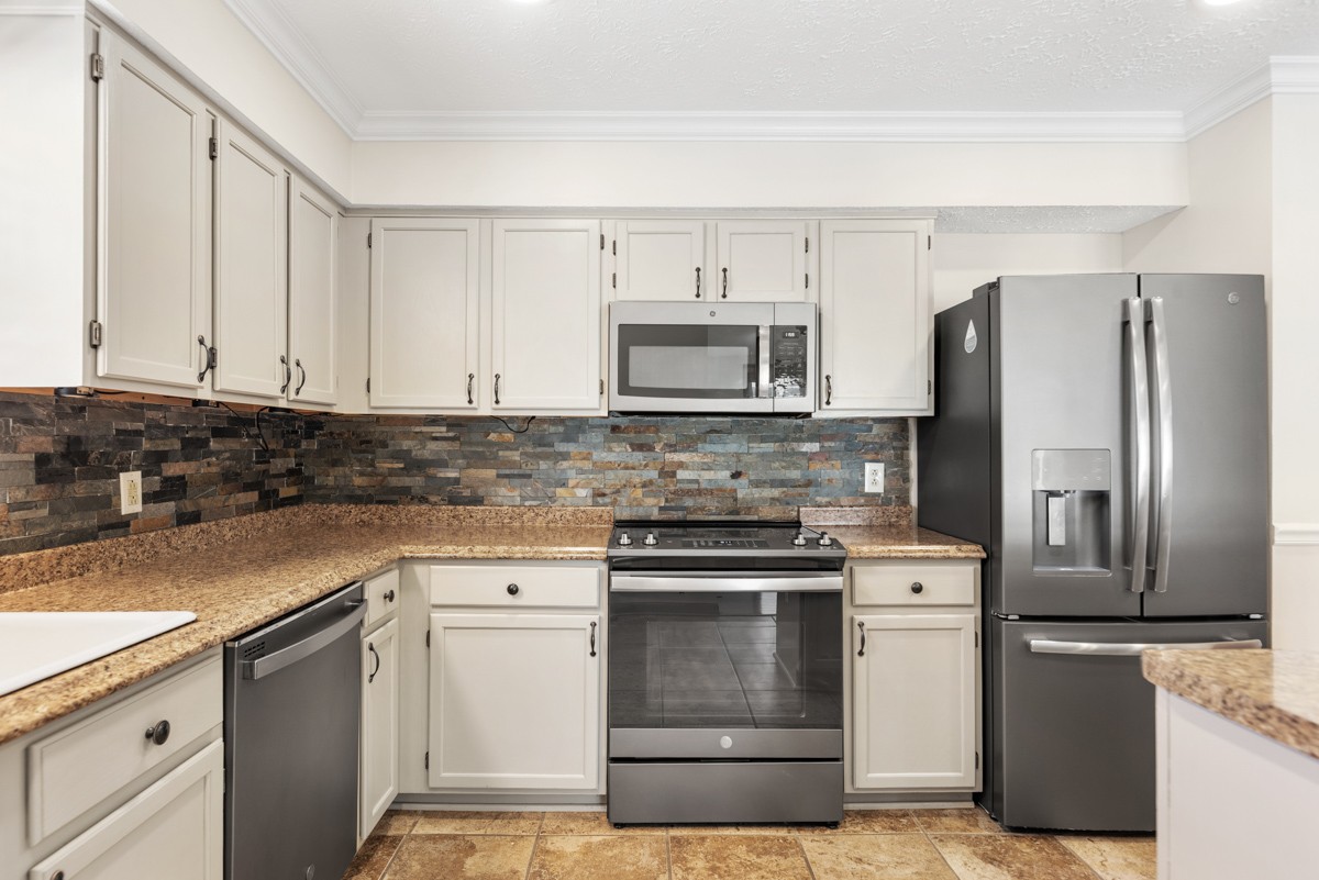 526 Calista Road White House, TN 37188 - Photo 9 of 29 a kitchen with cabinets stainless steel appliances and a counter space