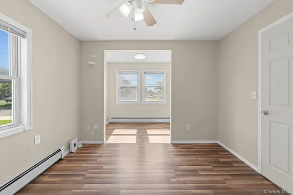 wooden floor in an empty room with a window