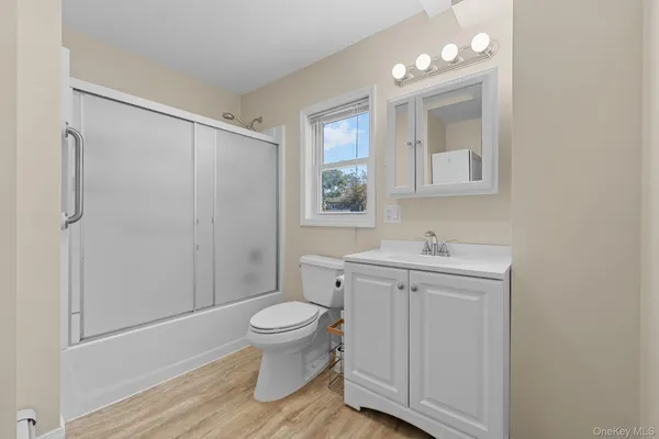 a bathroom with a toilet a sink and shower