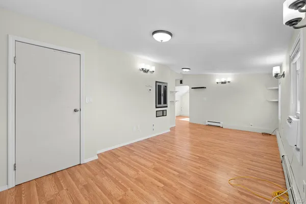 a view of empty room with wooden floor