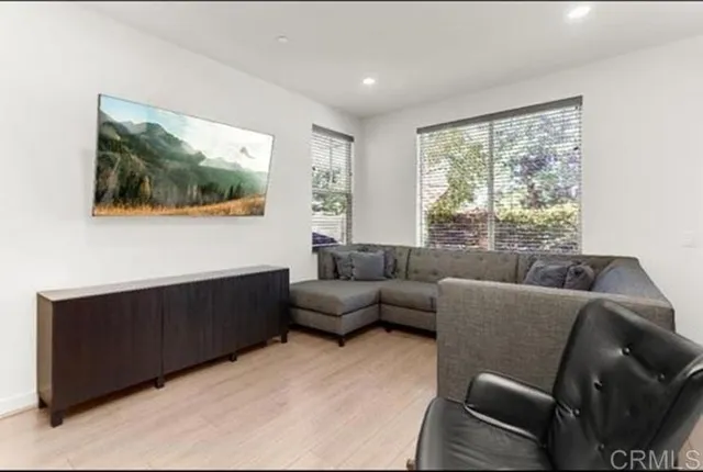 a living room with furniture and a floor to ceiling window