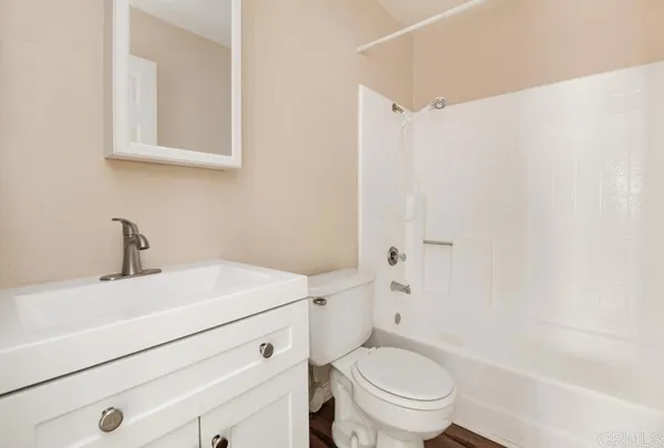 a bathroom with a sink a toilet and a bathtub