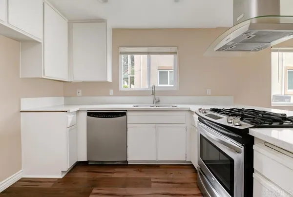 a kitchen with a stove oven and sink