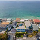 an aerial view of a house with a ocean view