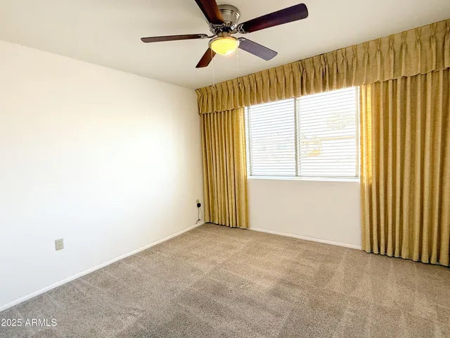 a view of a big room with a chandelier fan