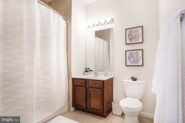 a bathroom with a toilet a sink and a mirror