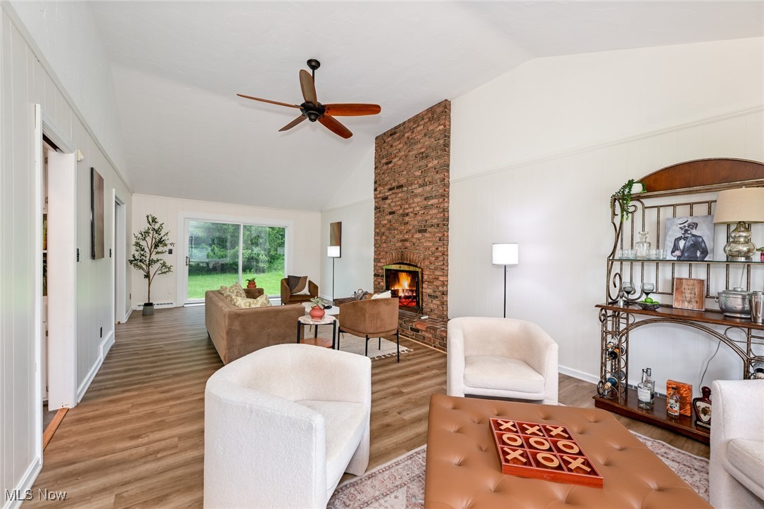2015 Burlington Road Akron, OH 44313 - Photo 4 of 50 Living area featuring lofted ceiling, ceiling fan, wood finished floors, a fireplace, and baseboards